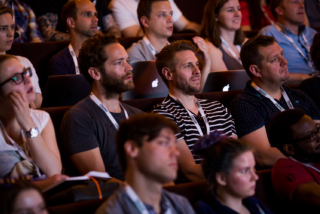 Conference attendees listening to a talk.